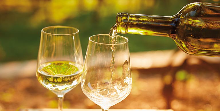 White wine being poured into glasses